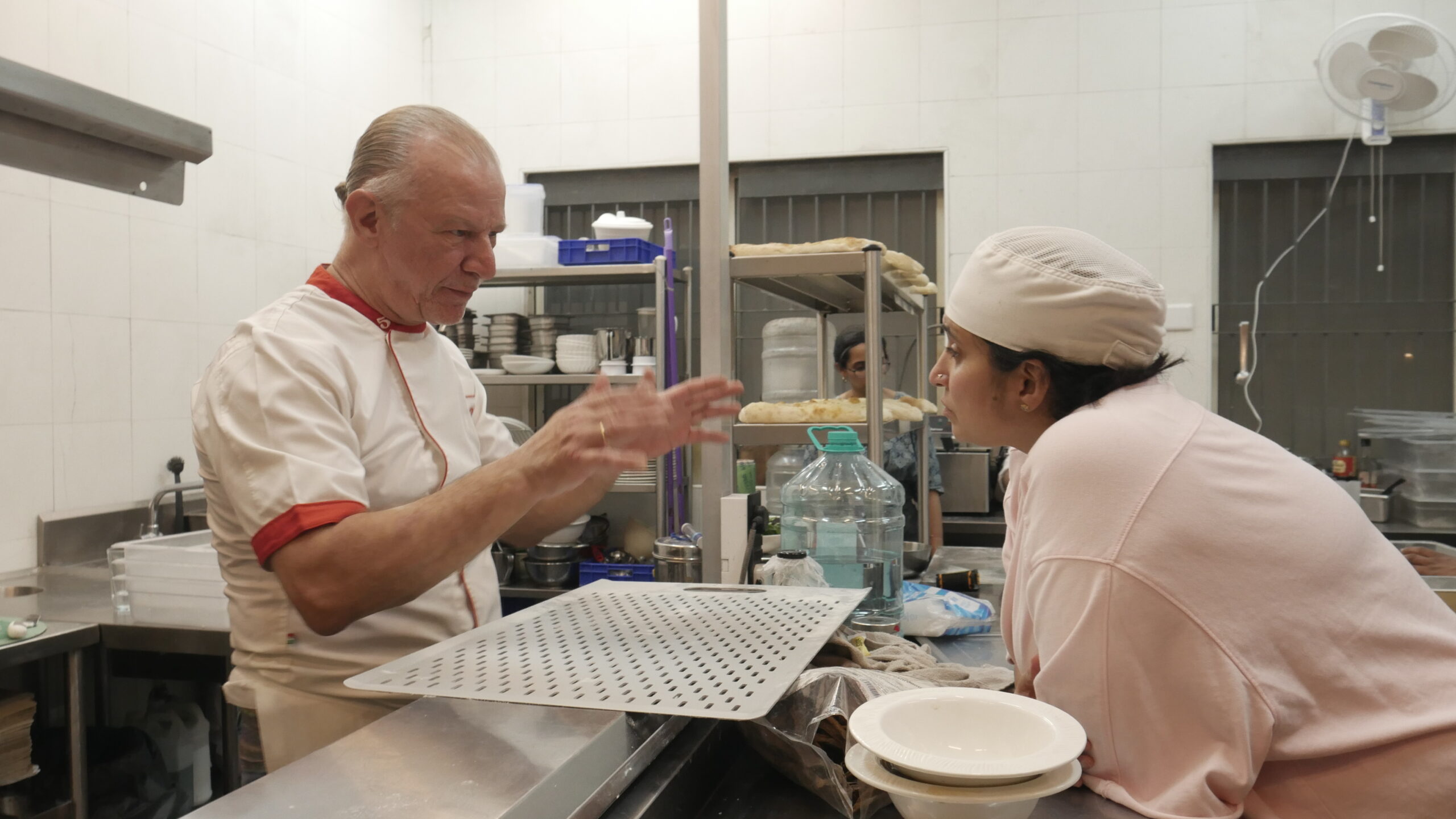 Chef Riccardo training Niharika Peri in the pala technique