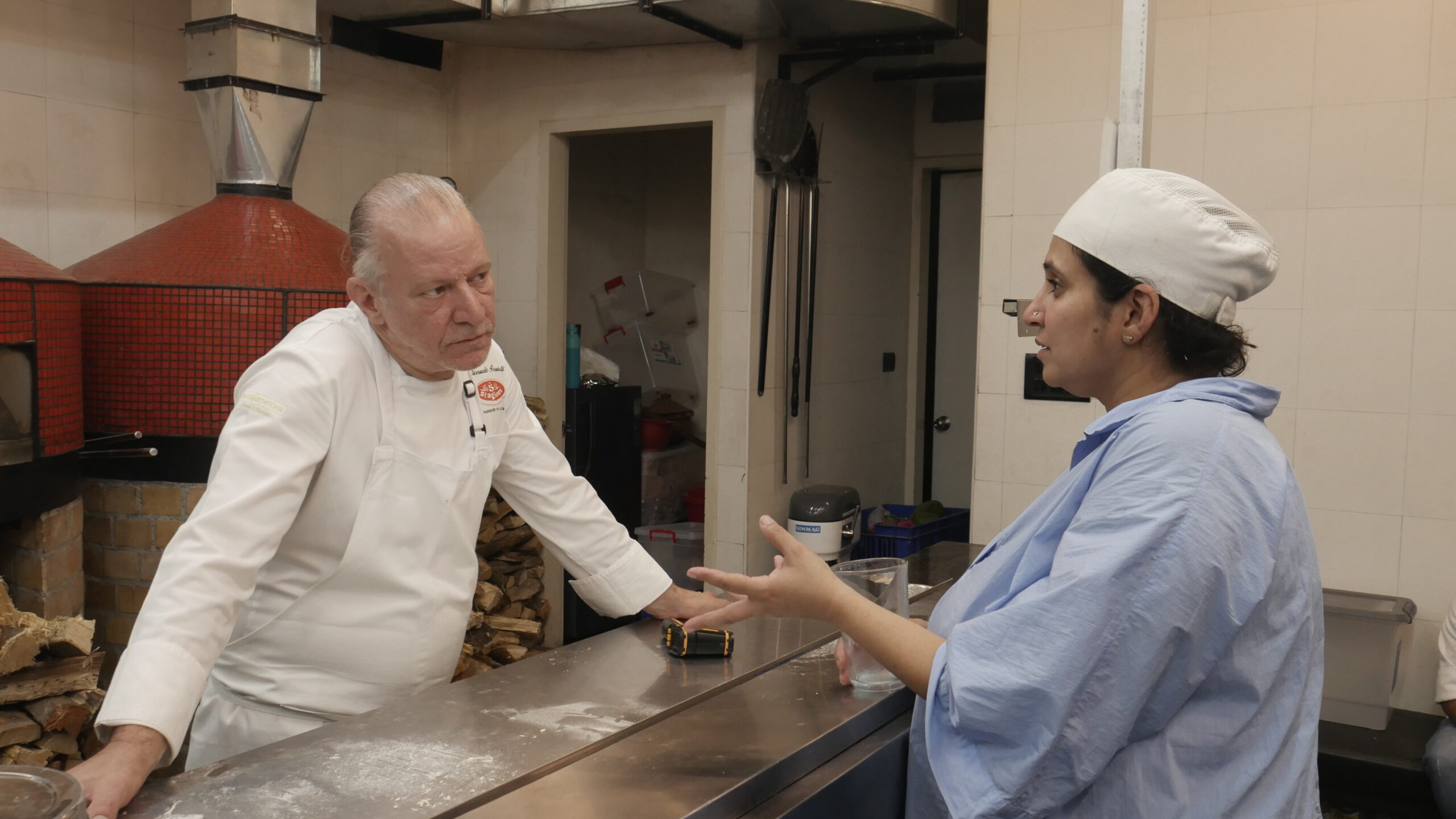 Chef Riccardo training Niharika Peri in the pala technique